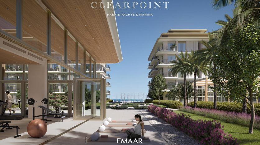 A luxurious gym with bay windows overlooking a marina, with a person doing yoga in front. The architecture features sleek, modern designs, making it an ideal investment in Dubai, with lush landscaping.