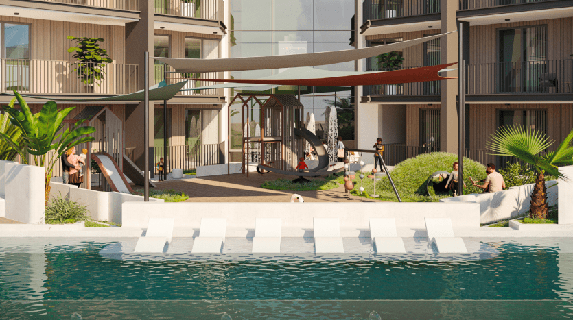 Un complexe d'appartements moderne à Dubaï dont les résidents bénéficient d'équipements tels qu'une aire de jeux, un coin salon ombragé au bord d'une piscine réfléchissante, une verdure luxuriante et des balcons.