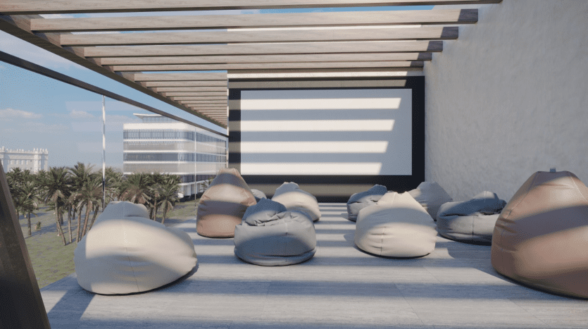 Espace de projection de films en plein air avec grand écran, poufs sur une terrasse, sous une pergola, avec un océan et des palmiers en arrière-plan par une journée ensoleillée, parfait pour un immobilier sur le thème de Dubaï