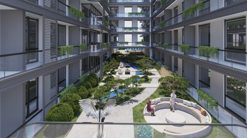 Une cour spacieuse et moderne d'un complexe d'appartements à Dubaï comprenant des jardins paysagers, des sentiers pédestres et des coins salons, où les résidents profitent du plein air, entourés de bâtiments à plusieurs étages ornés de balcons verts.
