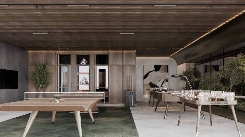 Espace de loisirs de bureau moderne avec une table de ping-pong, une table de baby-foot, un café-bar avec tabourets et un salon de relaxation dans le cadre d'une villa de Dubaï, avec des accents en bois élégants et un design contemporain.