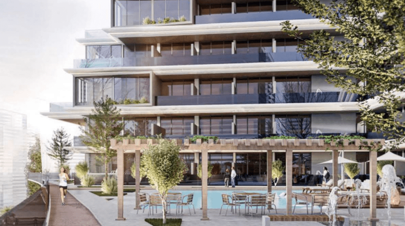 Immeuble d'appartements moderne à Dubaï doté de balcons spacieux dotés d'un espace commun extérieur paysager avec des sièges et des arbres. Les gens interagissent avec désinvolture dans un cadre animé.