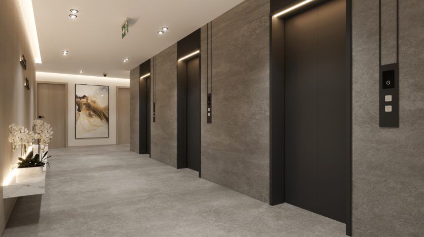 Un hall d'ascenseur moderne et élégant avec deux ascenseurs fermés, des panneaux gris et noirs, un éclairage élégant et une peinture décorative au bout du couloir, parfait pour un investissement à Dubaï