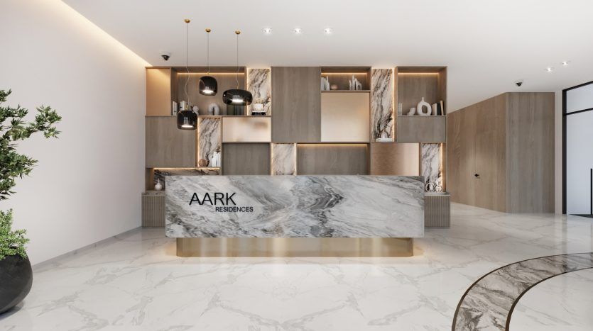 Un hall élégant doté d'un grand comptoir de réception en marbre, avec des murs lambrissés et une décoration minimaliste. Le sol est orné d'élégants motifs de marbre, caractéristiques de l'immobilier de haute qualité à Dubaï, et