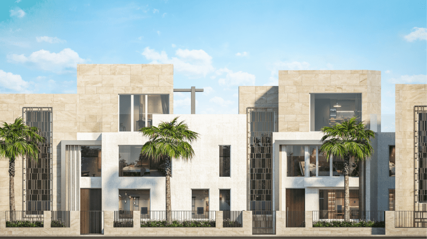 Maisons de ville modernes aux façades en pierre et en verre sous un ciel bleu clair, avec balcons, palmiers et éléments de conception géométrique distincts, présentées par une agence immobilière de premier plan à Dubaï.