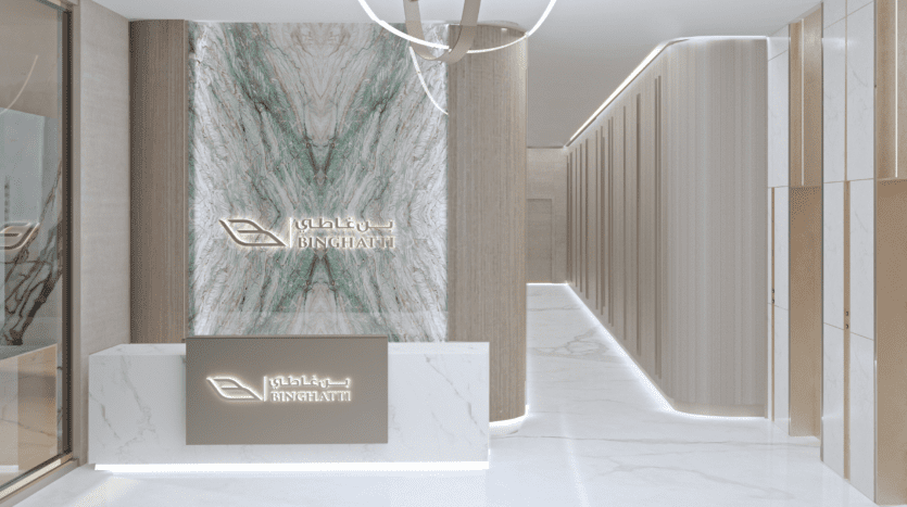 Hall d'entrée d'entreprise moderne avec un bureau de réception élégant arborant un logo d'entreprise en caractères arabes et anglais, entouré de murs en marbre et de boiseries élégantes, généralement vu dans une agence immobilière haut de gamme de Dubaï.