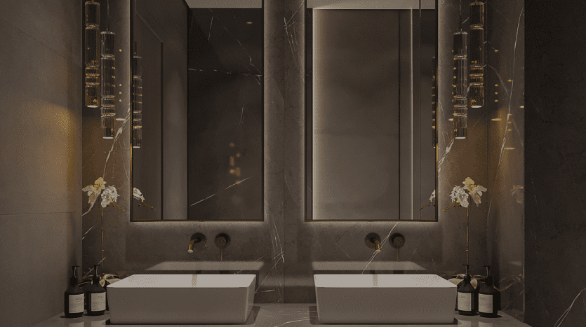 A luxurious bathroom in a Dubai villa featuring two square sinks beneath large vertical mirrors, accented with gold pendant lights and white orchids, all set against a dark marble wall.