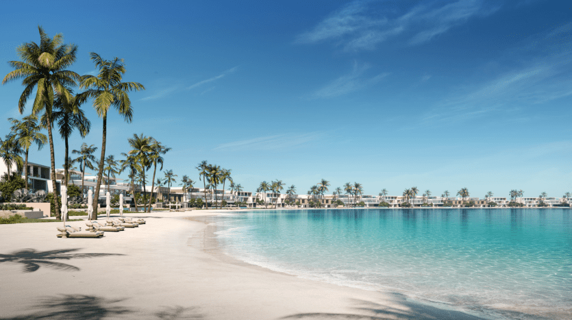 Une station balnéaire tranquille de Dubaï avec des palmiers, des villas modernes bordant le rivage et des eaux bleues claires sous un ciel lumineux. Des chaises longues sont disséminées le long de la plage de sable.