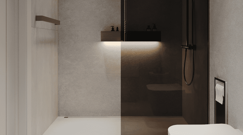 Une salle de bains moderne dans une villa de Dubaï présentant un design minimaliste avec une cloison de douche en verre, des luminaires sombres et élégants et des murs lisses aux tons neutres éclairés par un éclairage doux.