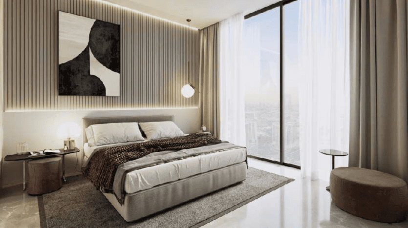 Chambre moderne dans un appartement de Dubaï avec un grand lit, une literie grise et un jeté marron. Des œuvres d'art monochromes artistiques au-dessus du lit, flanquées de lumières verticales et de fenêtres sur toute la longueur offrant une lumière naturelle.