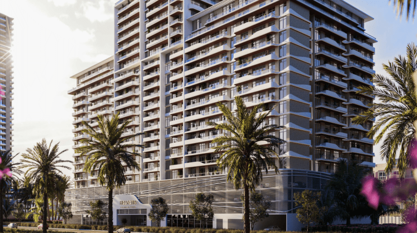 Immeubles résidentiels modernes de grande hauteur à Dubaï avec des palmiers et un ciel dégagé, présentant un mélange d'éléments de design urbain et tropical avec un ensoleillement important.