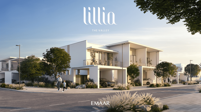 Un développement résidentiel moderne à Dubaï comprenant d'élégantes villas blanches avec de vastes terrasses, un aménagement paysager luxuriant et des gens marchant sur des sentiers ensoleillés, avec les logos « Iilia The Valley » et « EMAAR » en bas.