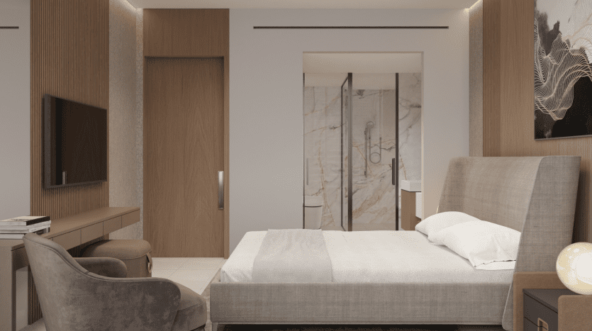 Une chambre moderne dans une villa de Dubaï comprenant un lit king-size avec des tissus d'ameublement gris, des meubles en bois et un mur en marbre menant à une salle de bains privative.