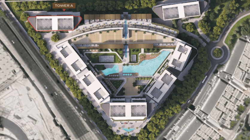 Vue aérienne d'un complexe hôtelier de luxe avec piscines, entouré de bâtiments symétriques étiquetés "Tour A" au sommet. Le complexe bénéficie d'une verdure luxuriante et se trouve à proximité d'une autoroute de Dubaï.