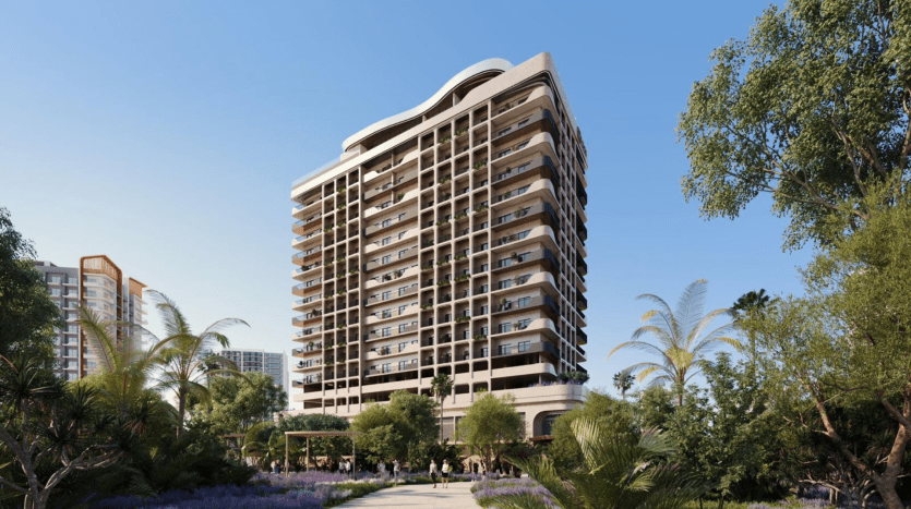 A modern high-rise residential building surrounded by lush gardens, with people walking on paths and palm trees swaying in the foreground under a clear blue sky, available via a premier Dubai real estate agency.
