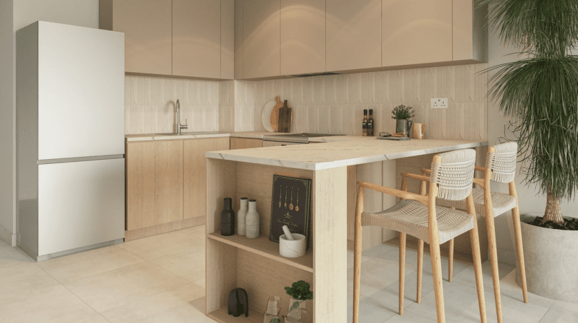 Modern kitchen interior in a Dubai villa with neutral tones, featuring a wooden island, cabinets, high stools and a potted plant, creating a clean, elegant space.
