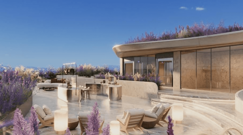 A luxurious outdoor terrace in a Dubai apartment featuring modern furnishings, with an open space displaying elegant seating and a built-in bar counter. The scene is wrapped in lush lavender and features a clear, sunny sky.