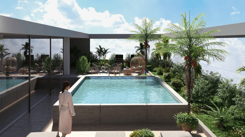 Une femme en robe se tient au bord d’une élégante piscine à débordement sur le toit d’un appartement de luxe à Dubaï, entourée d’une verdure luxuriante et de meubles modernes en osier, surplombant une ligne d’horizon sous un ciel clair.