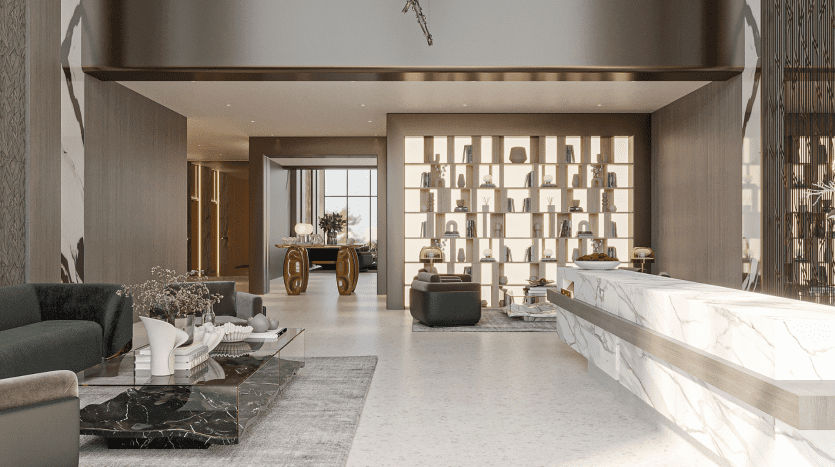 L'intérieur moderne du Primero Residences Al Furjan présente un plan d'étage ouvert et spacieux comprenant un coin salon avec des canapés verts et une table basse en marbre noir. Un bureau de réception en marbre se trouve à proximité et une étagère rétroéclairée présentant des objets décoratifs borde le mur.