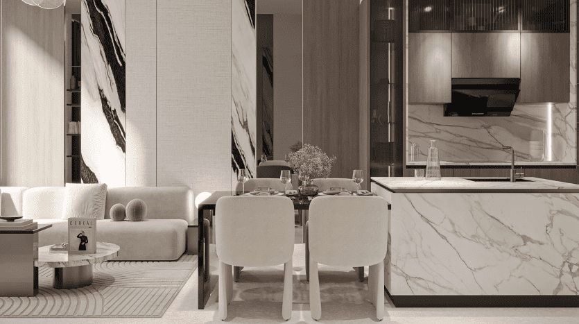 Le salon et salle à manger moderne et minimaliste du Primero Residences Al Furjan comprend un canapé de couleur claire, une table basse ronde avec un livre et une table à manger pour quatre personnes. La cuisine dispose d'un îlot en marbre, d'appareils électroménagers intégrés et d'armoires élégantes. Les murs verticaux d'accent en marbre rehaussent le décor élégant.