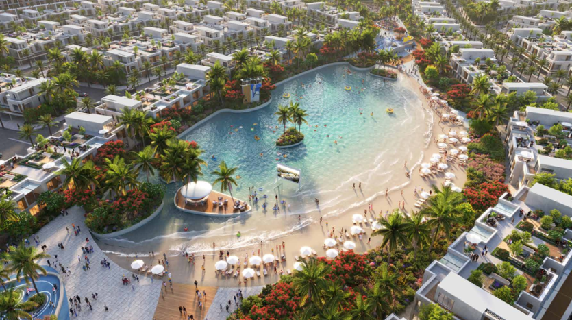 Vue aérienne d'un complexe luxueux doté d'une grande piscine de style lagon entourée d'une végétation tropicale luxuriante et de nombreuses villas blanches sous un ciel ensoleillé dans le sud de Dubaï.
