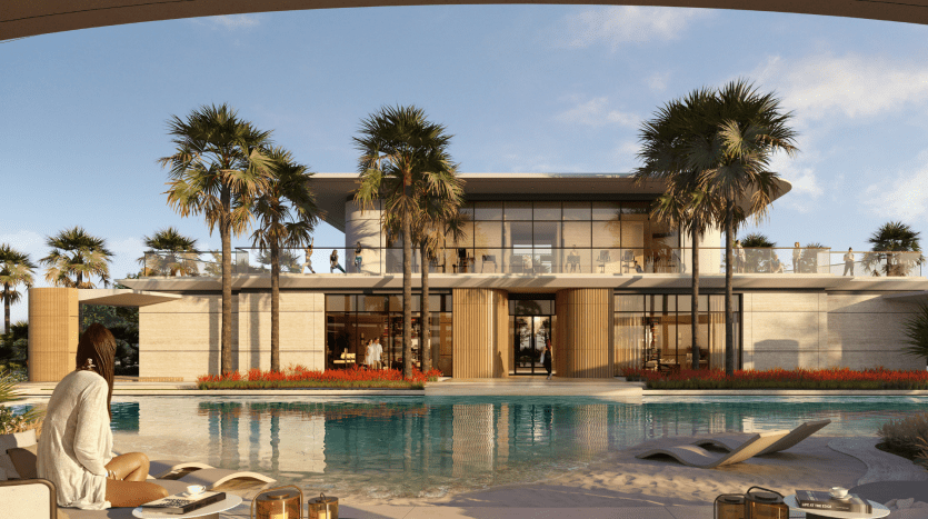 Une villa moderne et luxueuse avec de grandes baies vitrées et une piscine entourée de palmiers. Une femme se détend sur une chaise longue au bord de la piscine et profite de l’environnement serein.