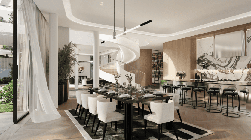 Luxueuse salle à manger décloisonnée de la Villa Karl Lagerfeld avec une élégante table à manger noire, des chaises blanches, un escalier en colimaçon et un espace bar avec des tabourets verts. Les grandes fenêtres permettent une lumière naturelle abondante.