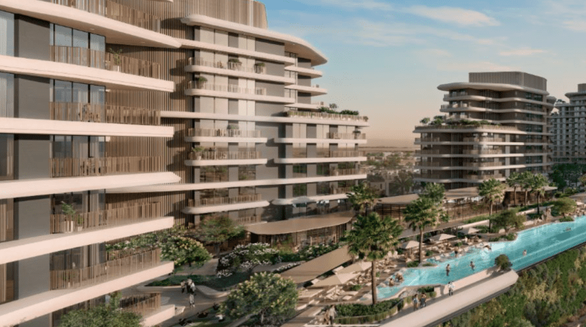 Un complexe résidentiel moderne, Verdes, composé de plusieurs bâtiments à plusieurs étages avec des balcons incurvés et de grandes fenêtres, entourés de verdure paysagère. Au premier plan, une longue piscine surélevée avec transats et parasols invite à la détente.