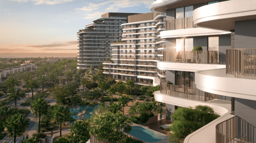 Des gratte-ciel résidentiels modernes surplombent un espace communautaire luxuriant et arboré doté d'une piscine. La conception architecturale comprend des balcons incurvés et de grandes fenêtres. Le soleil se couche, projetant une lueur chaleureuse sur le paysage avec des palmiers visibles, créant une scène pittoresque à Verdes.