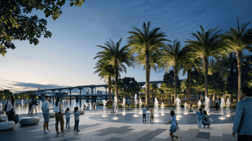 People enjoy a beautifully landscaped park with tall palm trees, water fountains and children playing around. A bridge rises in the background as dusk sets in, creating a serene ambiance over the bustling urban setting near Address Residences.