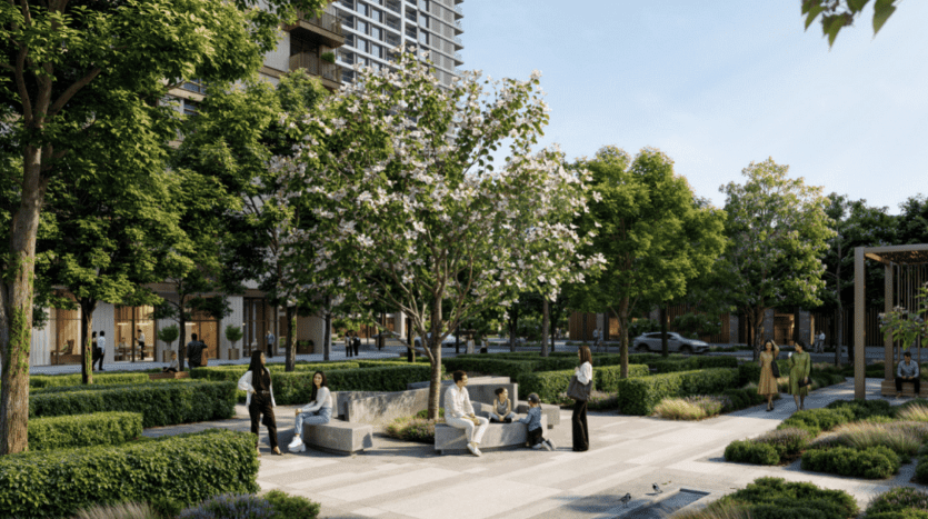 A community park with lush vegetation, trees and various plants. People sit on benches, walk and interact. A large building belonging to Address Residences can be seen in the background. The atmosphere seems calm and welcoming.