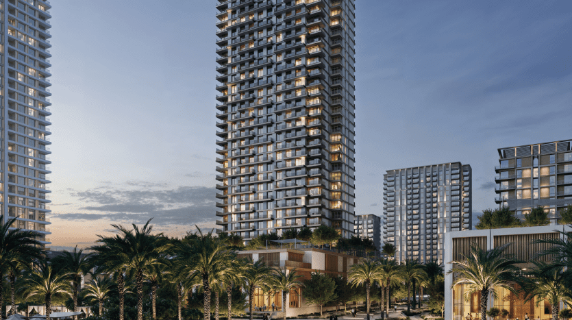 High-rise buildings like Address Residences, illuminated at dusk, surrounded by palm trees and greenery. The sky changes from sunset to evening, with scattered clouds. The scene captures an urban residential area with modern architecture and a serene atmosphere.