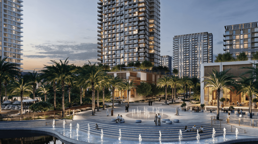 A twilight scene of a modern urban square with several high-rise residential buildings, including Address Residences, in the background. The square is adorned with tall palm trees, illuminated fountains, and people strolling and relaxing leisurely, creating a lively and serene atmosphere.