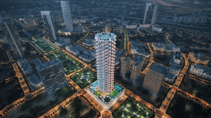 Vue aérienne d'un paysage urbain de nuit avec le Binghatti Royale, un gratte-ciel au design unique et lumineux au centre. Le bâtiment est entouré de rues en damier et de structures modernes, avec des arbres et des sentiers illuminés qui renforcent l'ambiance urbaine.
