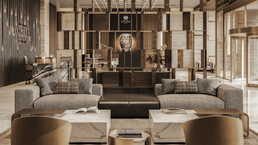 Un hall d'hôtel moderne et luxueux au décor sophistiqué. L'espace comprend des canapés gris moelleux, des tables basses en marbre avec des livres ouverts, des coussins à motifs, des fauteuils élégants, une cloison avec des ouvertures géométriques et un comptoir de réception élégant accentué par des tons sombres et un éclairage d'ambiance.