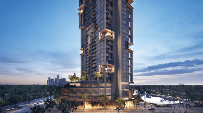 The Highgrove, a modern high-rise skyscraper, features illuminated sections and lush vegetation on balconies against a twilight sky. In the foreground, a tree-lined street with cars leads to a body of water on the right, while urban buildings in the distance adorn the horizon.