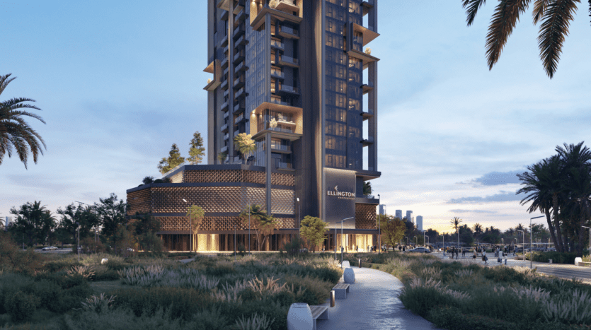 The Highgrove, a modern multi-storey building with vertical gardens, rises gracefully in the distance. Surrounded by lush trees and greenery, a serene path invites visitors to move forward under the clear sky, reinforcing the calm ambience of the early evening.