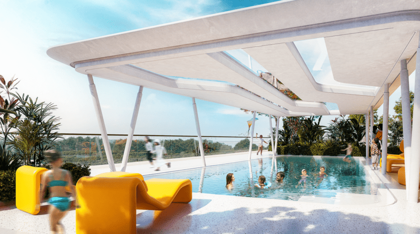 La piscine sur le toit de l'Amaal 8 présente un design moderne et épuré. Plusieurs personnes, dont des enfants, profitent de l'eau. Des chaises longues jaune vif décorent la terrasse et des plantes luxuriantes bordent le périmètre. Le ciel est clair et ensoleillé, parfait pour une journée en plein air.