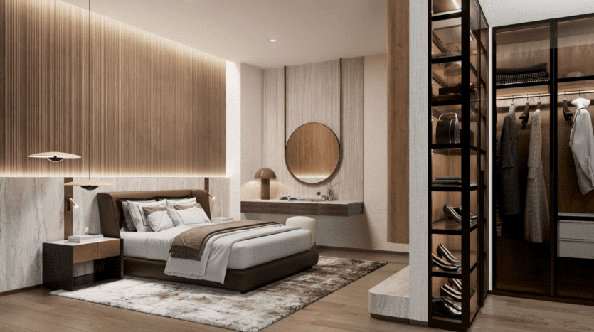 Une chambre moderne avec un grand lit avec une literie beige et marron, un miroir circulaire au-dessus d'une coiffeuse élégante et un placard ouvert éclairé débordant d'élégance LIV Maritime. Des vêtements suspendus et des étagères mettent en valeur le bois chaleureux et les tons neutres qui s'écoulent dans tout l'espace.
