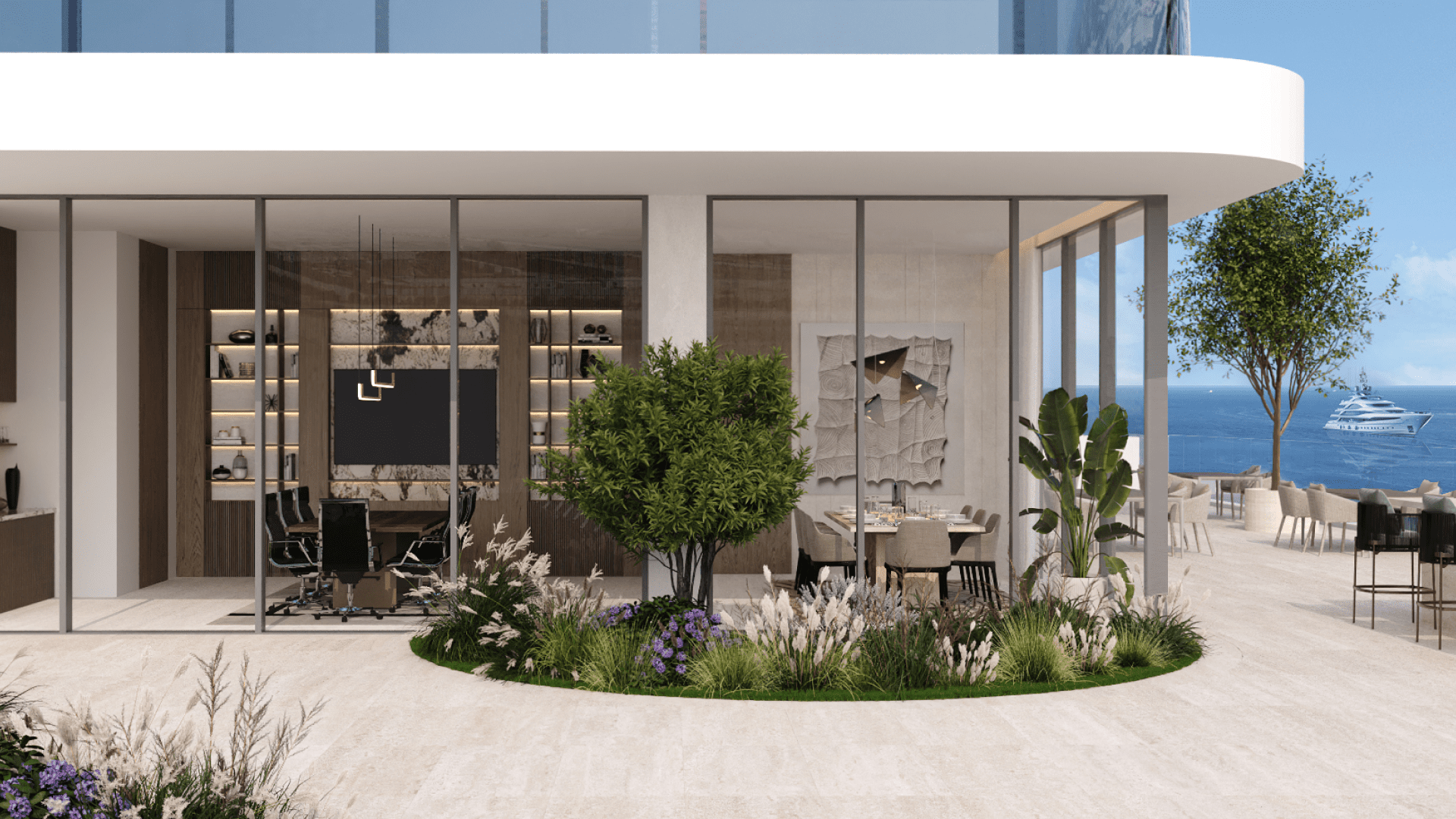 Un espace de bureau moderne avec de grandes baies vitrées donnant sur l'océan incarne l'esprit maritime de LIV. À l'intérieur, des bureaux et des chaises élégants complètent les étagères et les œuvres d'art sur les murs. Un petit arbre et des plantes décorent le patio, tandis qu'un yacht est visible au loin.