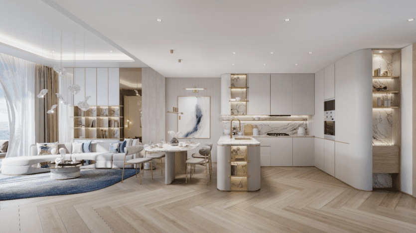 Une cuisine et un salon modernes et ouverts inspirés de Sunset Bay, avec des planchers en bois clair, des armoires blanches et des comptoirs en marbre. Une table à manger avec des chaises se trouve à côté de la cuisine. Le salon dispose d'un canapé incurvé qui invite à la détente près d'une grande fenêtre ornée de rideaux transparents.
