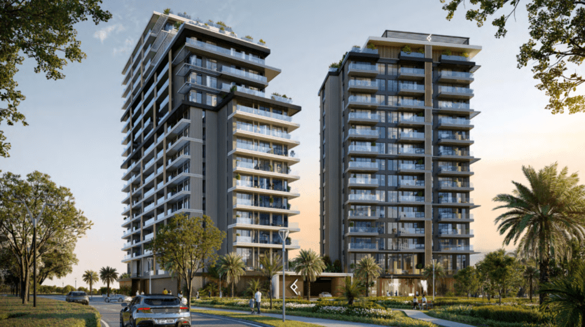 Deux immeubles modernes de grande hauteur, faisant partie du complexe Hillgate, sont entourés de verdure et de palmiers sous un ciel dégagé. Une route avec une voiture et des passants au premier plan mène de manière accueillante à l'entrée de cette oasis urbaine.