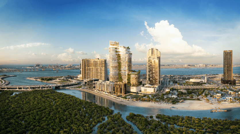 Vue aérienne de Rivage, un paysage urbain côtier présentant des immeubles modernes de grande hauteur au bord d'un cours d'eau et des mangroves verdoyantes. L'horizon sous un ciel bleu clair met en valeur le mélange harmonieux du développement urbain et du paysage naturel.