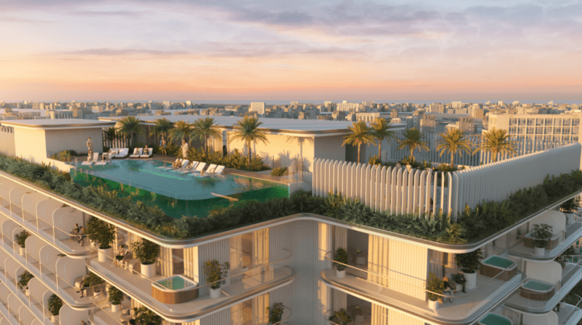 Le Cove Edition 3 propose une luxueuse piscine à débordement sur le toit, entourée de palmiers et de chaises longues, au sommet d'un gratte-ciel moderne. Au coucher du soleil, il offre une vue imprenable sur le paysage urbain en contrebas.