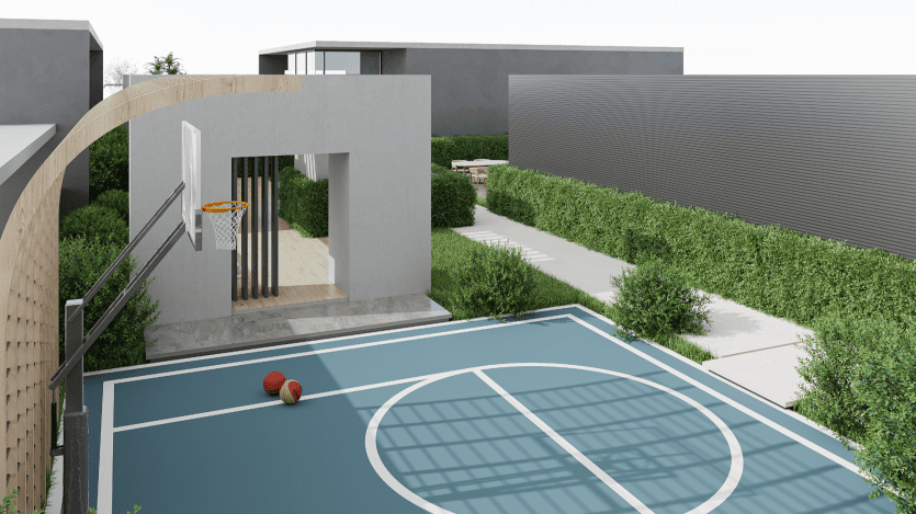 Un terrain de basket-ball moderne en extérieur avec deux ballons sur la surface bleue. Un bâtiment minimaliste se trouve à l'arrière-plan, entouré de haies vertes et d'un chemin.