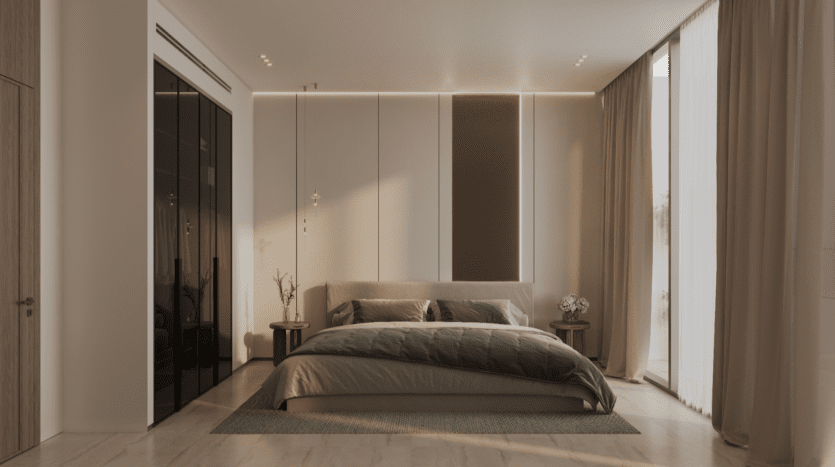La chambre moderne Binghatti Elite comprend un grand lit avec des coussins décoratifs foncés et une couverture grise. Des murs blancs avec un panneau marron complètent les grands rideaux sur la droite. Deux tables d'appoint accueillent de petites plantes, tandis qu'un éclairage doux ajoute de la chaleur à cet espace élégant.