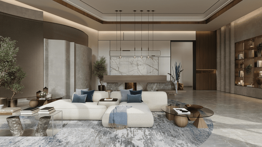 Un salon moderne avec un canapé d'angle blanc orné de coussins bleus et gris. Une table basse géométrique en bois et des tables d'appoint rondes complètent le décor. La pièce comprend un mur d'accent en marbre, un éclairage suspendu, des plantes et un tapis texturé.