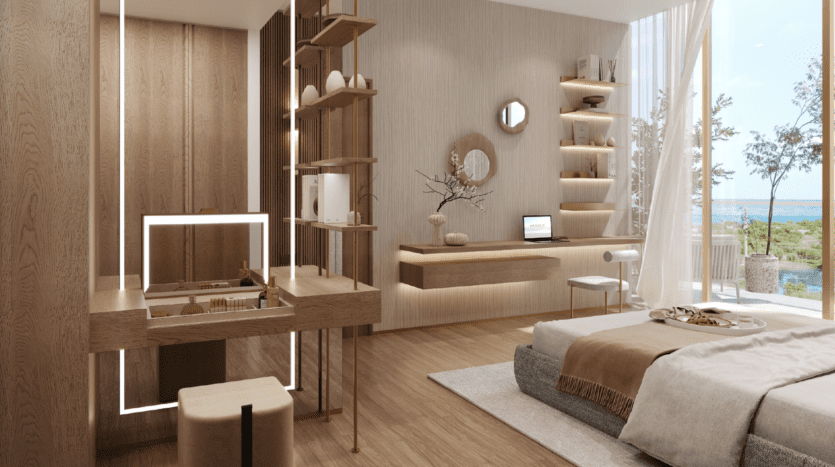 Une chambre moderne et minimaliste avec des meubles en bois clair, des étagères ouvertes, un lit confortable avec une literie neutre, un bureau flottant avec un ordinateur portable et de grandes fenêtres offrant une vue sur les arbres et l'eau de l'île de Wynnwood Dubaï.