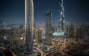 Dubai's nighttime cityscape, with towering illuminated skyscrapers, including the Burj Khalifa and Binghatti Skyblade, surrounded by city lights, busy roads and urban buildings.