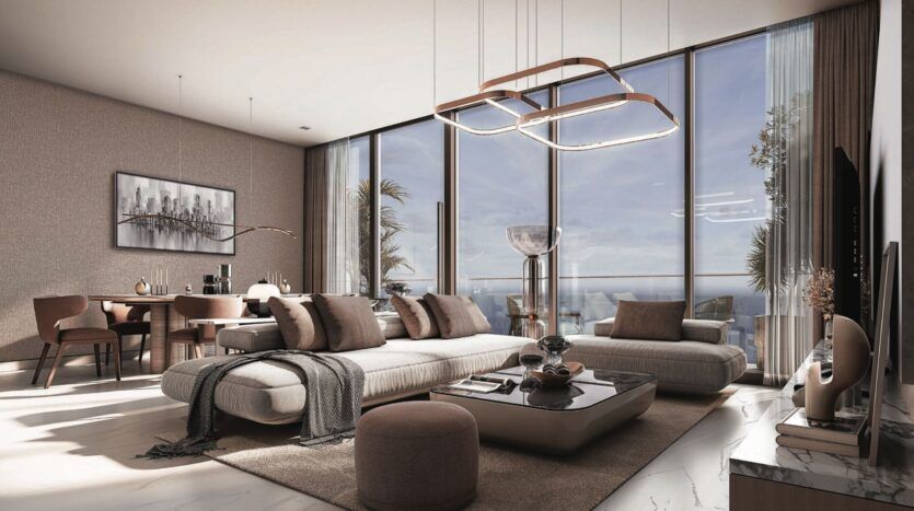 Salon moderne avec de grandes fenêtres allant du sol au plafond, des meubles de couleur neutre et une table basse élégante. La lumière du soleil pénètre à l'intérieur, offrant une vue panoramique sur l'océan SkyParks depuis la salle à manger à l'arrière-plan.
